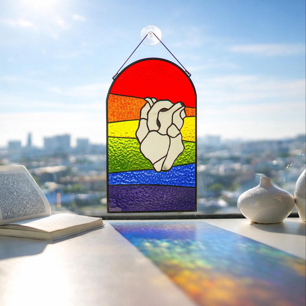 Rainbow stained glass suncatcher with mirror heart design, colorful LGBT pride window decor hanging in sunlight
