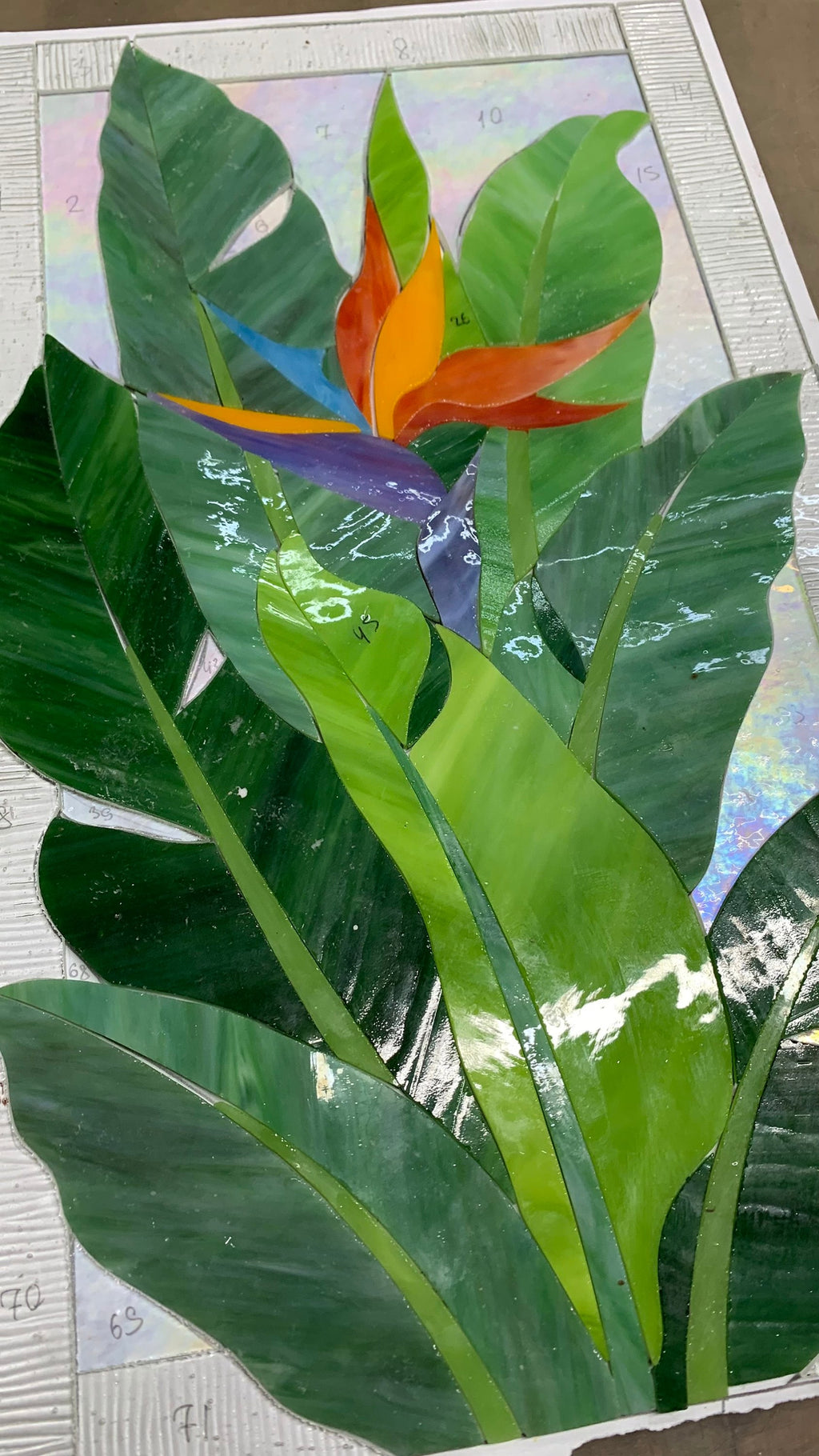 Bird of Paradise stained glass panel in progress, copper foil wrapped glass pieces before soldering
