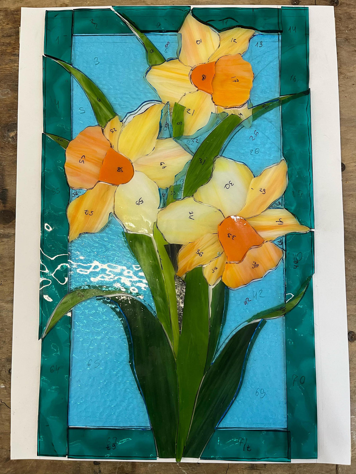 Glass pieces for handmade daffodil stained glass panel, Tiffany copper foil technique in progress