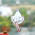 Handmade stained glass ghost suncatcher with red heels hanging in a sunny window, Tiffany copper foil technique