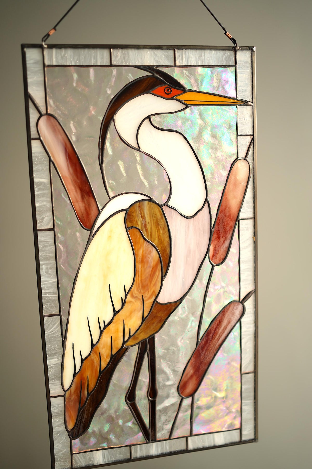 Front view of stained glass white heron panel with amber reeds, handmade Tiffany style window art
