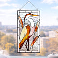 Handmade stained glass heron panel with reeds, hanging in a sunny window, Tiffany copper foil technique