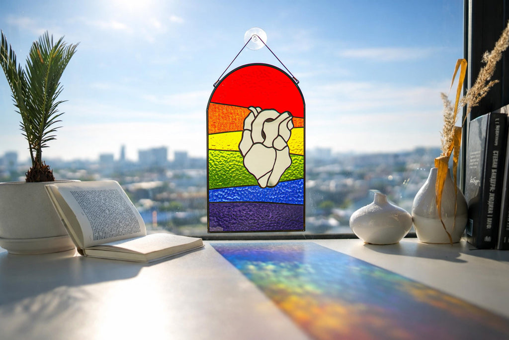 Rainbow stained glass suncatcher with mirror heart design, colorful LGBT pride window decor hanging in sunlight