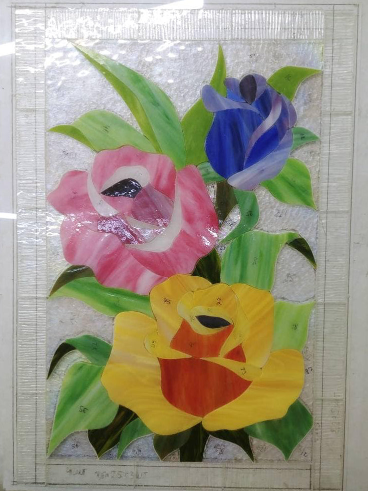 Glass pieces for handmade multicolored roses stained glass panel, Tiffany copper foil technique in progress