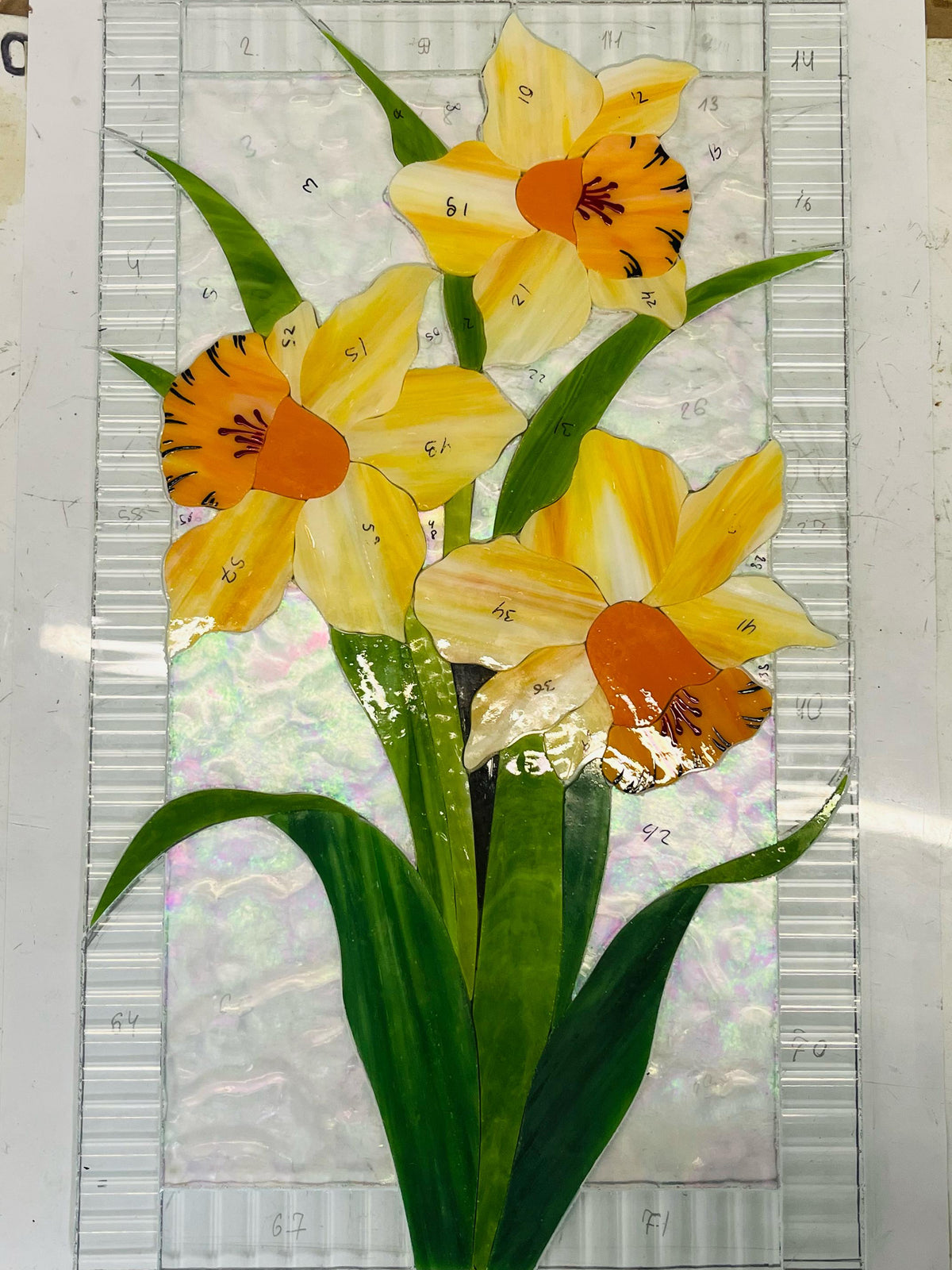 Glass pieces for handmade narcissus stained glass panel, Tiffany copper foil technique in progress