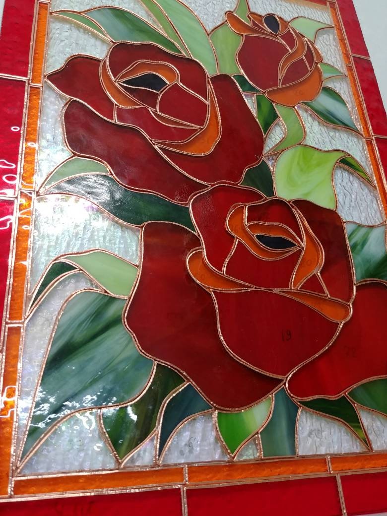Glass pieces for handmade red rose stained glass panel, Tiffany copper foil technique in progress