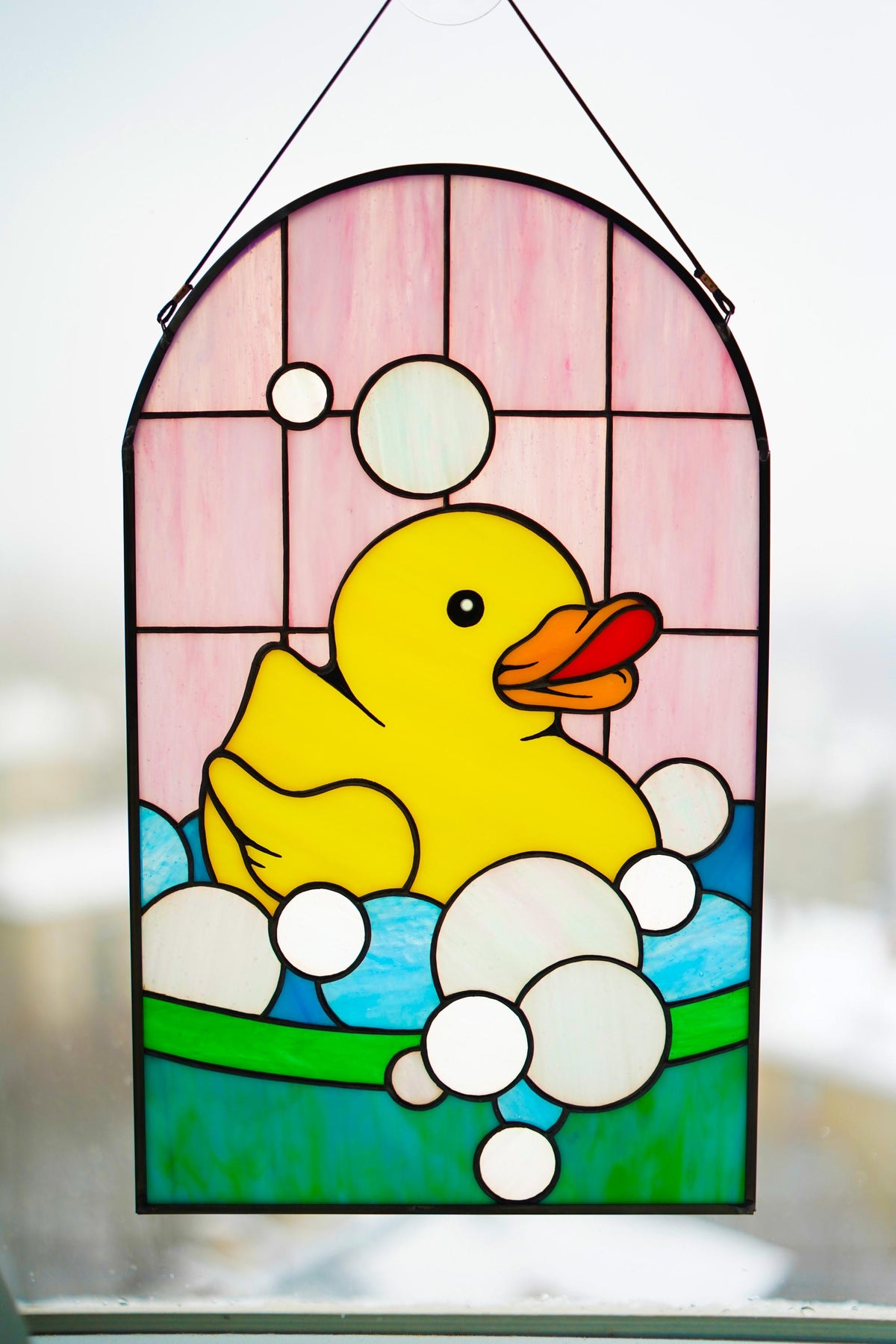 Front view of handmade rubber duck stained glass panel with bubbles, Tiffany style window art
