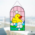 Handmade stained glass rubber duck panel hanging in a sunny window, Tiffany copper foil technique