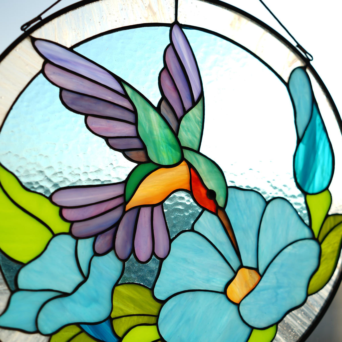 Round stained glass hummingbird panel front view, green and purple hummingbird with blue morning glory flowers, handmade Tiffany style window hanging
