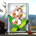 Handmade stained glass orchid panel on a windowsill with natural light, pink and white phalaenopsis orchids with green leaves, Tiffany copper foil, 16x12 inches
