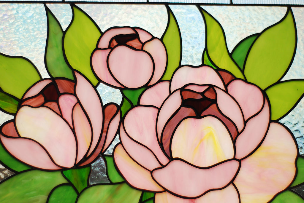 Close-up of stained glass pink peony panel showing opalescent petal detail and copper foil lines, soft blush and rose cathedral glass, handmade Ukraine
