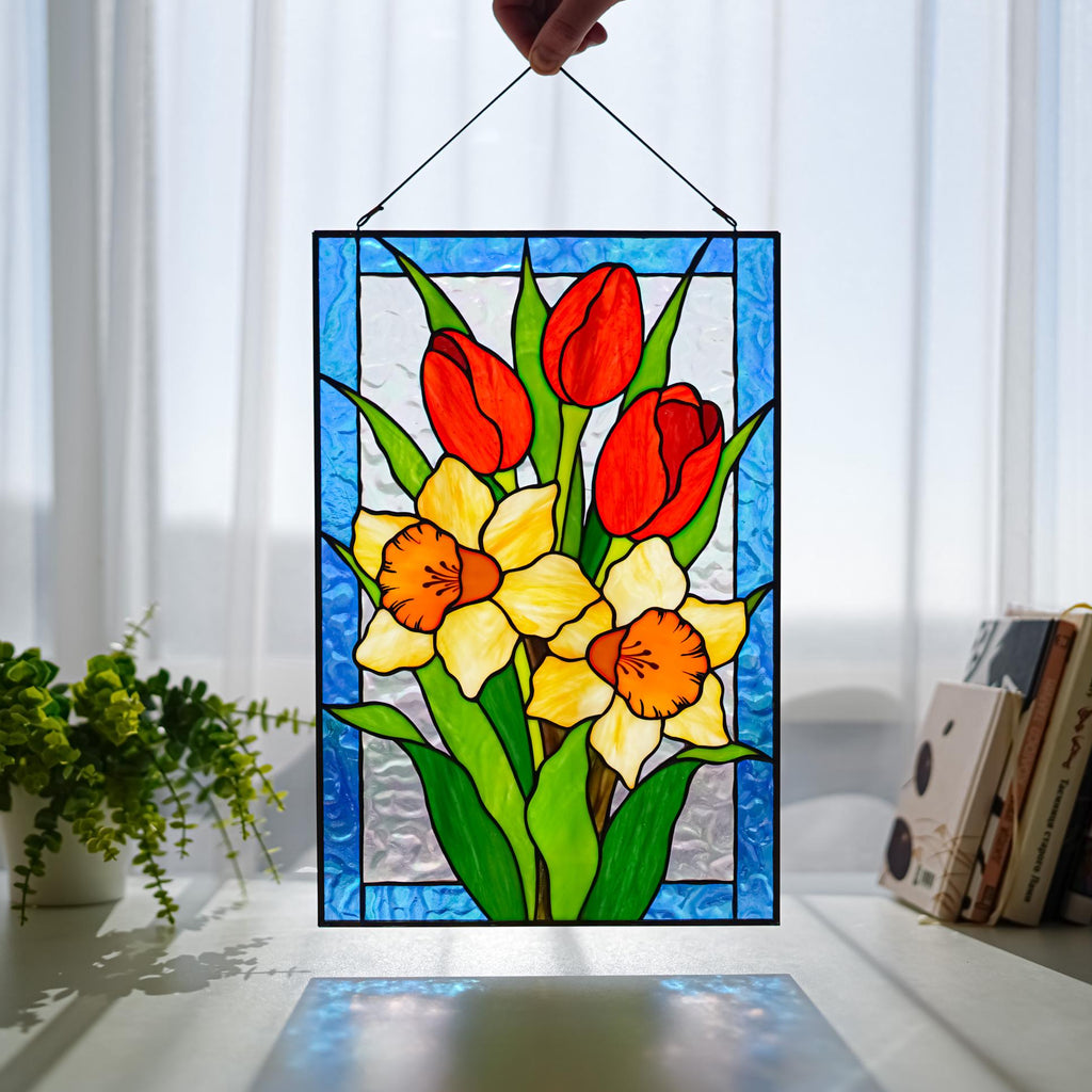Stained glass tulips and daffodils panel hanging in a bright living room window, Tiffany copper foil technique